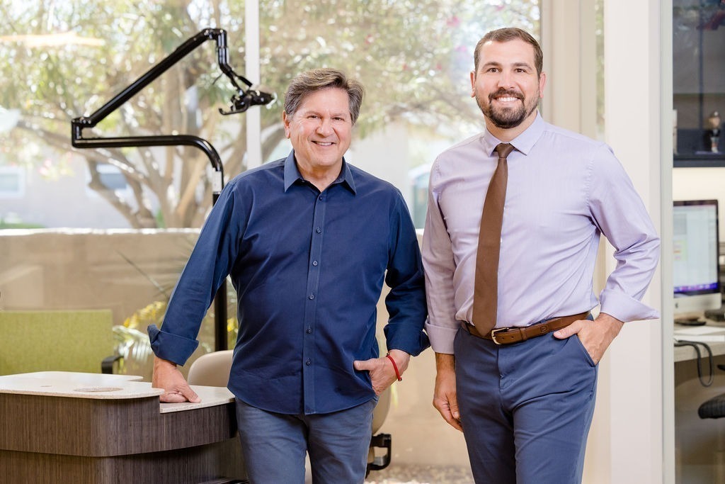 Orthodontists Dr. Paul Serrano and Dr. Andrew Serrano standing in the office of Serrano Orthodontics, promoting local orthodontic care in Phoenix, AZ.